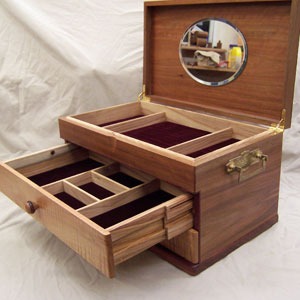 Wooden jewelry box with multiple drawers and compartments