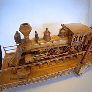 Wooden model of a vintage steam locomotive, featuring detailed craftsmanship