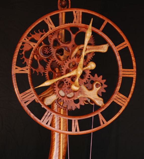 Intricate wooden wall clock featuring exposed gears and Roman numerals
